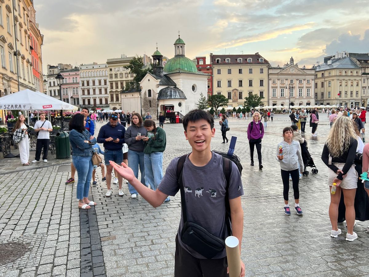 Ethan smiling in the Main Market Square in Kraków, Poland