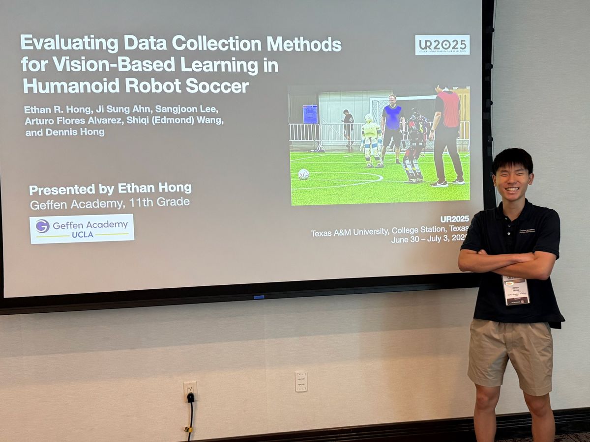 Ethan standing beside his title slide at the UR2025 conference