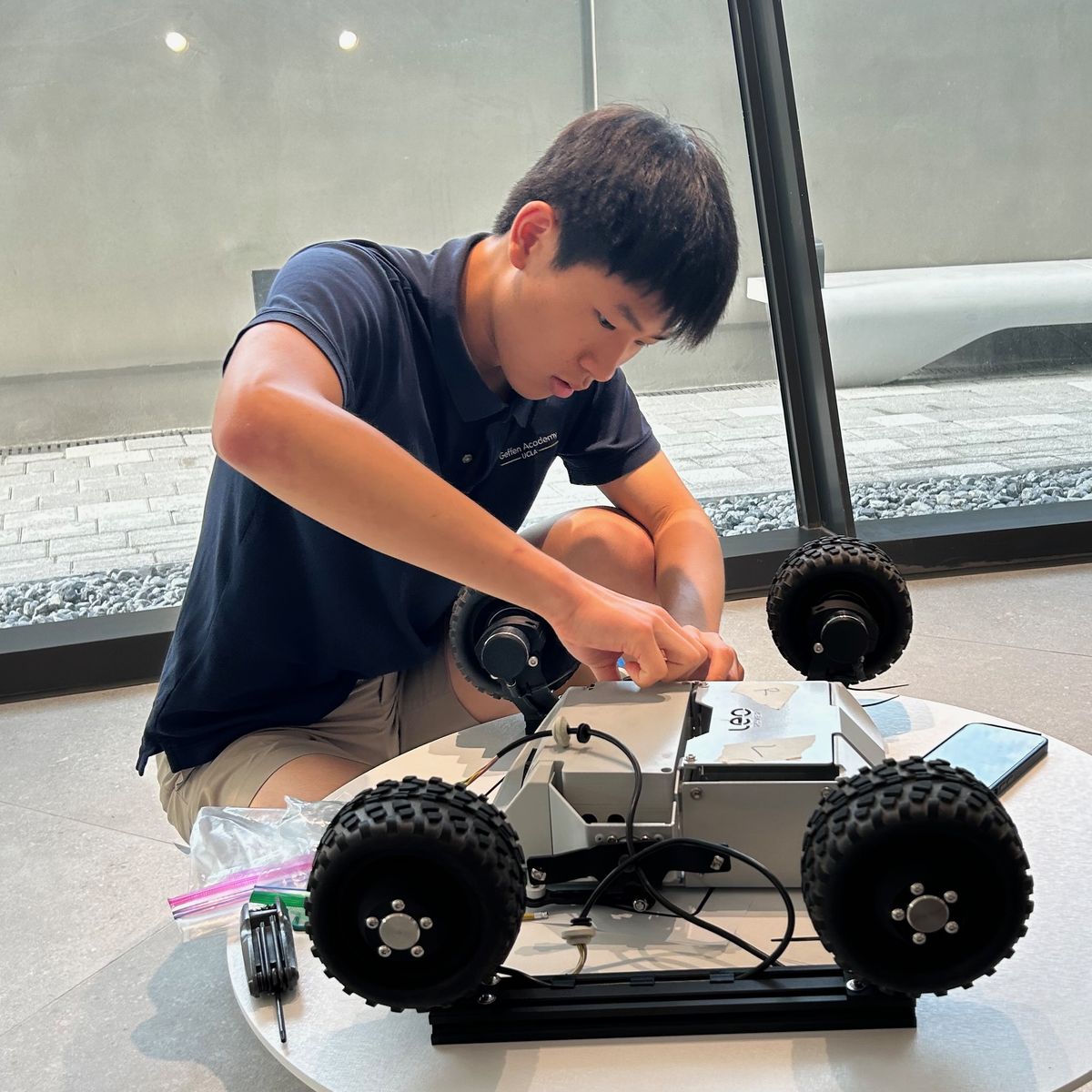 Ethan assembling the wheeled base of Food Angel